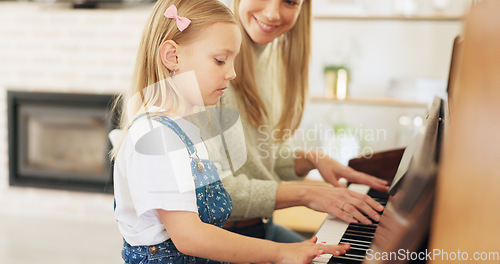 Image of Music development, girl learning piano and musical note education from mom in the home living room. A child musician playing keys, learn creative audio art and fun concert performance in family house