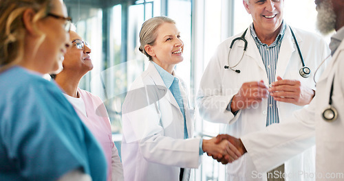 Image of Handshake, congratulations and healthcare, woman and black man shaking hands or applause for good job in medicine. Doctors, thank you and welcome to new recruit or partner at hospital with hand shake