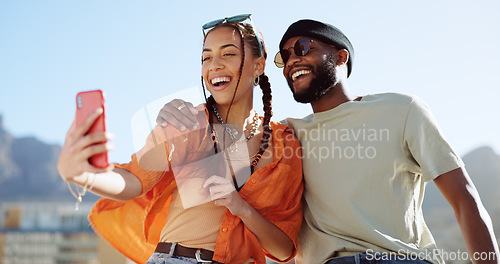 Image of Couple, bonding and phone selfie on city building rooftop on New York summer holiday, travel vacation date or social media memory. Smile, happy or black man and woman on mobile photography technology