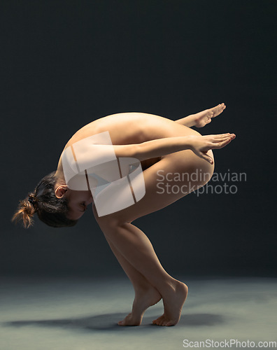 Image of Body, nude and ballet with a model woman in studio on a dark background for dance or performance arts. Creative, skin and beauty with a female ballerina posing naked on black for artistic freedom