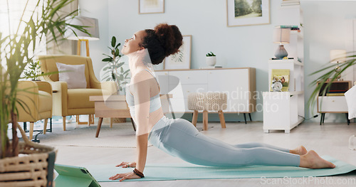 Image of Fitness, yoga or meditation stretching woman for workout in the living room of her house. Girl with chakra focus, mindset or balance while training, exercise or health with zen pilates for wellness.