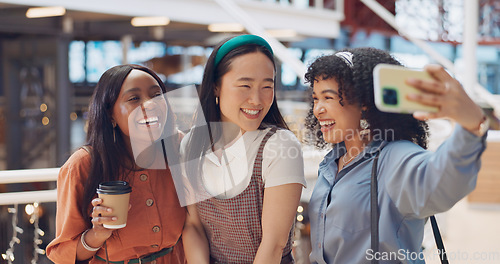 Image of Selfie, friends and social media with woman together posing for a photograph in a mall or shopping center. Phone, social media and smile with a happy female friend group taking a picture for fun