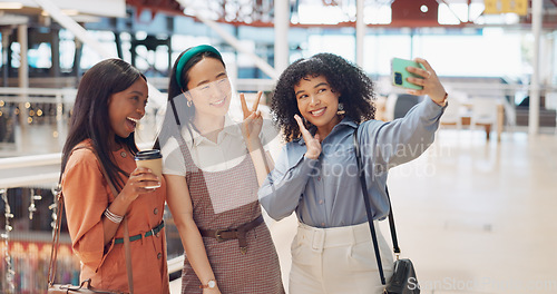 Image of Selfie, friends and social media with woman together posing for a photograph in a mall or shopping center. Phone, social media and smile with a happy female friend group taking a picture for fun