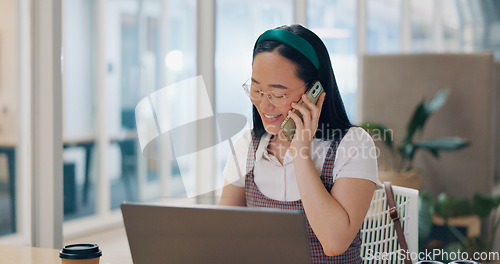 Image of Phone call, communication and business woman writing notes in office. Laptop, cellphone and Asian woman at desk on mobile smartphone chatting, speaking or business deal conversation with contact.