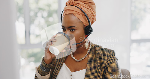 Image of Call center, customer service and black woman consultant in the office consulting online while drinking coffee. Customer support, telemarketing and professional African female crm expert in workplace