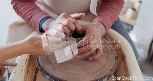 Image of Hands, pottery and clay with a man student learning from a female potter in the studio or ceramic workshop. Art, creative and sculpting with a woman teacher with a male artisan during a lesson