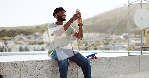Image of Smartphone, selfie and black man on rooftop for cityscape photography with skateboard relax outdoor. Happy man using phone or cellphone for social networking skate update of location