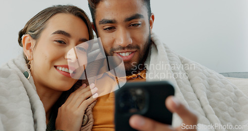 Image of Happy, couple with phone for communication, networking or social media app at home. Movie, video or love man and woman relax in living room streaming online, internet or website with smile in house