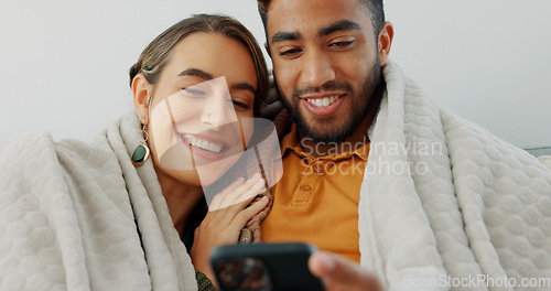 Image of Happy, couple with phone for communication, networking or social media app at home. Movie, video or love man and woman relax in living room streaming online, internet or website with smile in house