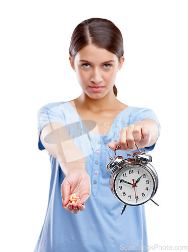 Image of Medicine, clock and portrait of a patient in a studio waiting to take pills, vitamins or supplements. Tablets, health and young woman with alarm as a medication reminder isolated by white background.