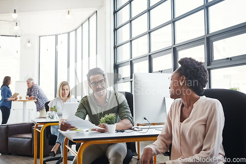 Image of Office, business and colleagues talking or in discussion while working on a project in a coworking space. Interracial, communication and corporate employees in a conversation or consult in workplace.