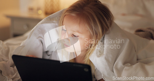 Image of Bed, games and girl child with tablet for evening leisure entertainment online with cozy duvet. Night, relax and young kid enjoying app gaming with cyber security tech in a comfortable bedroom.