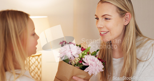 Image of Flowers, gift and happy with mother and girl for mothers day, birthday or congratulations in family home. Gratitude, smile and love with child giving bouquet to mom for present and celebration