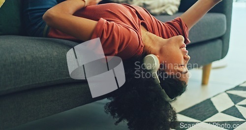 Image of Headphones, listening and dance of black woman on a sofa excited for subscription service, technology and home connection. Happy, relax and girl portrait dancing on couch while listening to music app