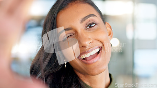 Image of Smiling, beautiful and fresh female face winking feeling fun, silly and playful. Portrait of a happy woman head with perfect skin and healthy teeth. Closeup of a carefree natural beauty with a smile
