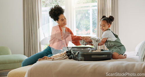 Image of Travel, luggage and mom packing with child in bedroom getting ready for trip. Helping hands, black family and young girl help mother pack clothes in suitcase for holiday, vacation and weekend away