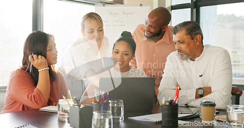 Image of Laptop, collaboration and meeting with a business team working together on a project in the office. Teamwork, computer and diversity with a man and woman employee group talking in the boardroom