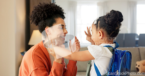 Image of Little girl kissing her mother. Young mother hugging her daughter. Loving mother hugging daughter before school outside. Little girl going to school. Happy woman embracing daughter