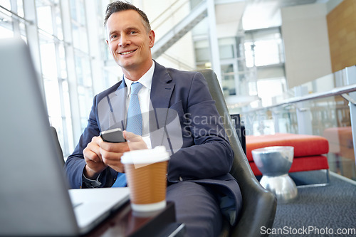 Image of Businessman smile, laptop and smartphone with company communication or social media with coffee while working. Contact, online and email with networking and worker in professional corporate lounge