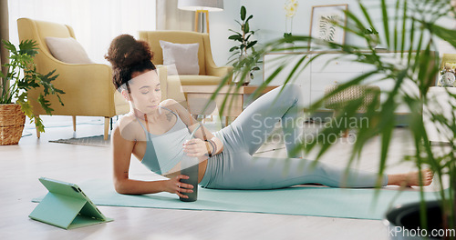 Image of Fitness, relax and woman drinking water in living room with tablet streaming online class for workout, health and exercise. Yoga, internet or e learning with athlete in home gym training for wellness