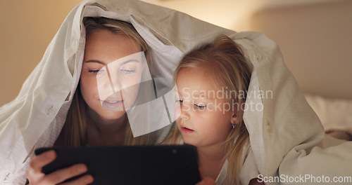 Image of Tablet, mother and girl with bedroom blanket fort at night in house on education website, learning or study game. Woman, child and digital technology in family home for internet ebook bedtime bonding