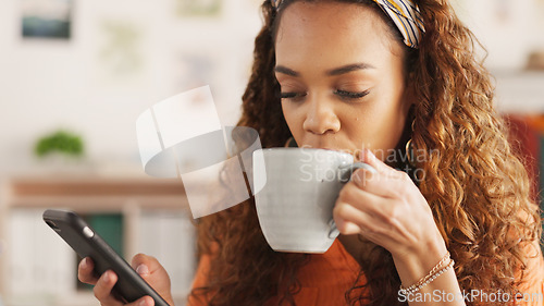 Image of Phone, coffee and communication with a black woman on social media while drinking from a mug in her home. Relax, mobile and internet with a young female enoying a cup of caffeine in her house