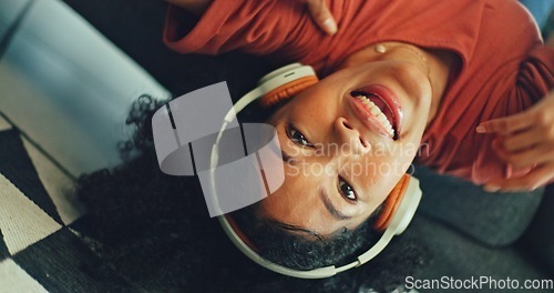 Image of Headphones, listening and dance of black woman on a sofa excited for subscription service, technology and home connection. Happy, relax and girl portrait dancing on couch while listening to music app