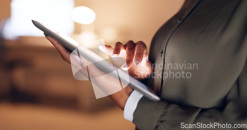 Image of Business, scrolling and hands of woman with tablet reading news, research and website content. Technology, digital gadget and businesswoman working online and browsing internet at night in the office