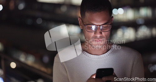 Image of Business man, phone and night data while online on an urban building rooftop typing email, search or communication for networking on trading app. Entrepreneur on terrace in dark with 5g network