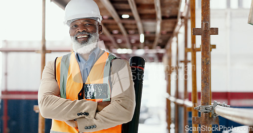 Image of Building engineer, architect and construction worker with a black man standing arms crossed with a positive mindset, motivation and vision on scaffold. Portrait of mature male contractor with a smile