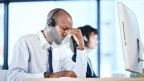 Image of Stress, burnout and headache by call center worker, employee and customer service consultant in office. Pain, mental health and depressed telemarking agent overworked and frustrated at the workplace