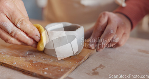 Image of Hands, pottery clay or wet sponge for creative sculpture, product manufacturing or mud mold in art studio, small business or startup. Zoom, man or ceramic artist in workshop design process with water