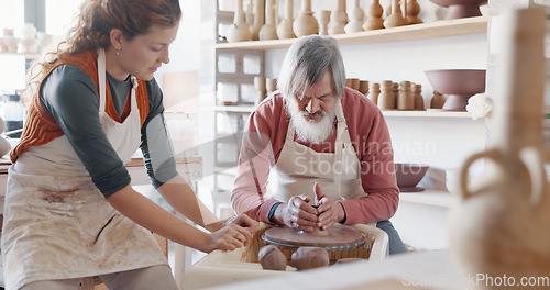 Image of Art, learning and people in a pottery class with a young potter in a workshop for diverse people. Design, texture and creative lesson with help from young woman discussing mold and shape process