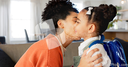 Image of Little girl kissing her mother. Young mother hugging her daughter. Loving mother hugging daughter before school outside. Little girl going to school. Happy woman embracing daughter