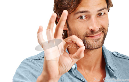 Image of Man, face and OK with hand in portrait, agreement or good review, feedback and emoji sign against studio background. Yes gesture, success and vote with approval and male voice positive opinion