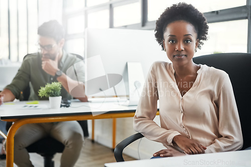 Image of Creative, black woman and office portrait at desk, sitting or focus with business people at web design agency. Webdesign woman, success and vision at table by corporate background for career goal