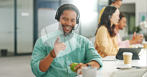 Image of Call center, customer service and a business black man writing in a notebook while working on a computer for sales. Computer, contact us and support with a male employee at work as a consultant