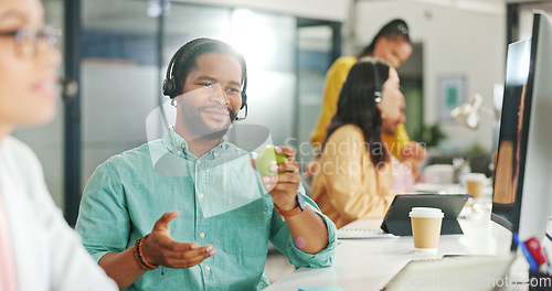 Image of Call center, customer service and a business black man writing in a notebook while working on a computer for sales. Computer, contact us and support with a male employee at work as a consultant