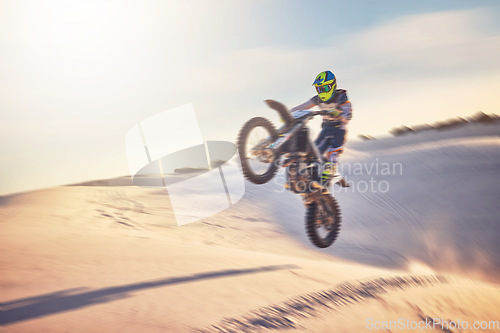 Image of Motorcycle, athlete and sports outdoor with jump stunt, fitness in desert and extreme sport with speed and freedom. Challenge, power and biking with exercise, person training and dirt bike rally