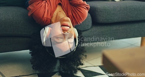 Image of Headphones, listening and dance of black woman on a sofa excited for subscription service, technology and home connection. Happy, relax and girl portrait dancing on couch while listening to music app