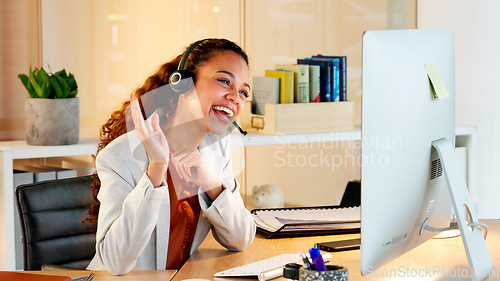 Image of A happy modern business woman having an online meeting at her computer. A cheerful worker talking during a corporate teamwork seminar. A female accountant on a company web conference at her desk.