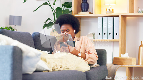 Image of Sick afro woman streaming on phone while coughing, suffering from covid fatigue and blowing her nose with tissue. Young woman watching movies on technology and ill with sinuses, cold or flu allergies