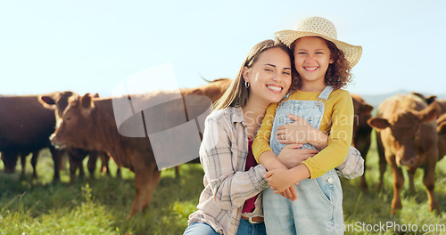 Image of Farming, child and mother with kiss on a farm during holiday in Spain for sustainability with cattle. Portrait of happy, smile and travel mom and girl with love while on vacation on land with cows