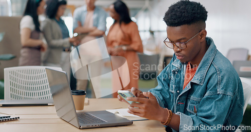 Image of Phone, laptop and creative man in the office networking on social media, mobile app and the internet. Technology, planning and African male marketing employee doing research and working on a project.