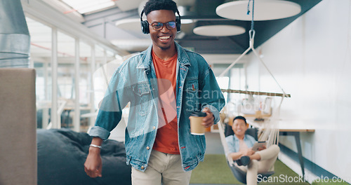 Image of Positive, motivation and high five with a business black man walking through the office while listening to music. Carefree, success and happy with a male employee greeting a colleague group at work