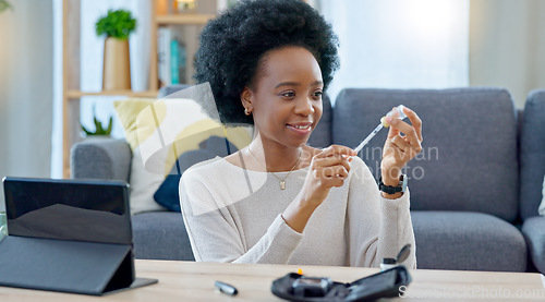 Image of Woman with syringe preparing an insulin injection at home with an online tutorial. One girl injecting self with medicine treatment to treat chronic illnesses type 1 2 diabetes, high blood or glycemia