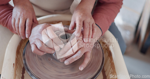 Image of Love, pottery and hands of old couple molding in workshop studio for creative art, support and ceramics class. Trust, marriage and retirement with man and woman with clay wheel on crafting date