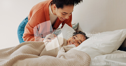 Image of Shot of mother waking up her adorable little girl from a nap in bed