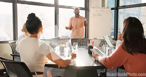 Image of Black man, leadership and presentation meeting in office boardroom for sales, marketing or advertising ideas. Whiteboard, coaching and mentor training with group of business people holding documents