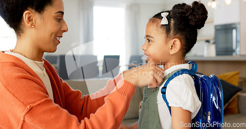 Image of Little girl kissing her mother. Young mother hugging her daughter. Loving mother hugging daughter before school outside. Little girl going to school. Happy woman embracing daughter